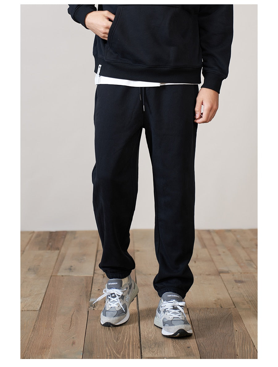 a man wearing black gym WRATH joggers 