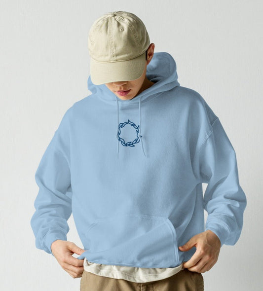 a man wearing sky blue WRATH hoodie with floral crown embroidered in the center chest