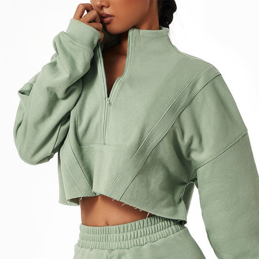 a woman wearing green  wrath   collar    zipper top